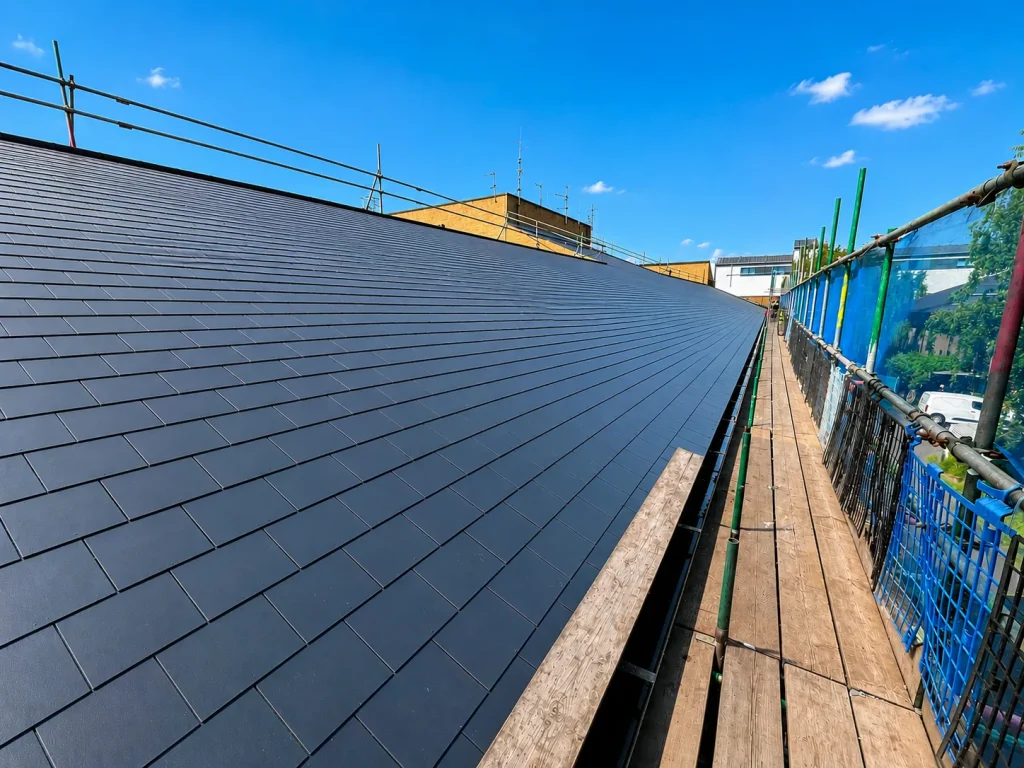 New slate roof installation with scaffolding by Astral Roofing